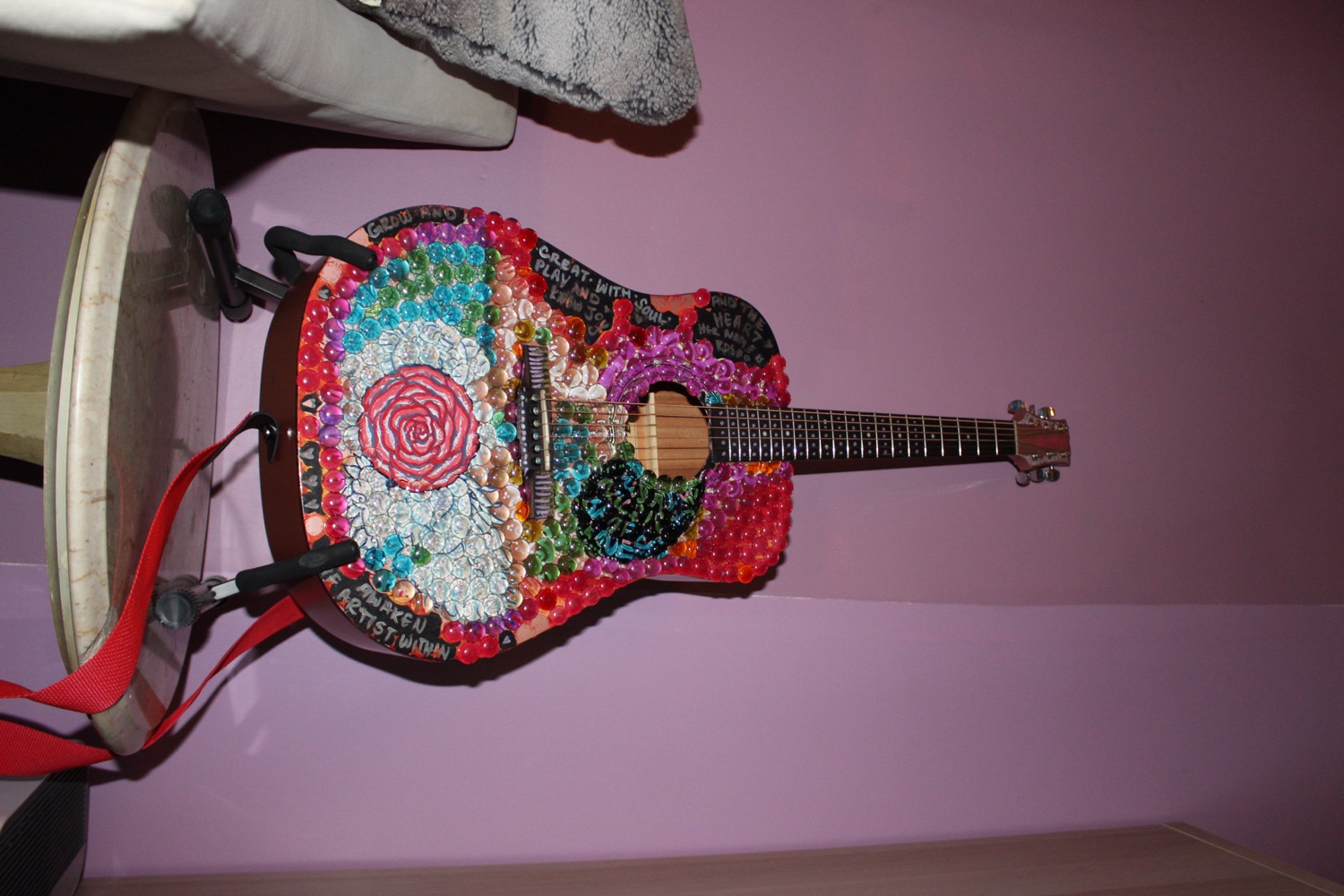 A decorated guitar in a cozy corner at Dear Eleanor